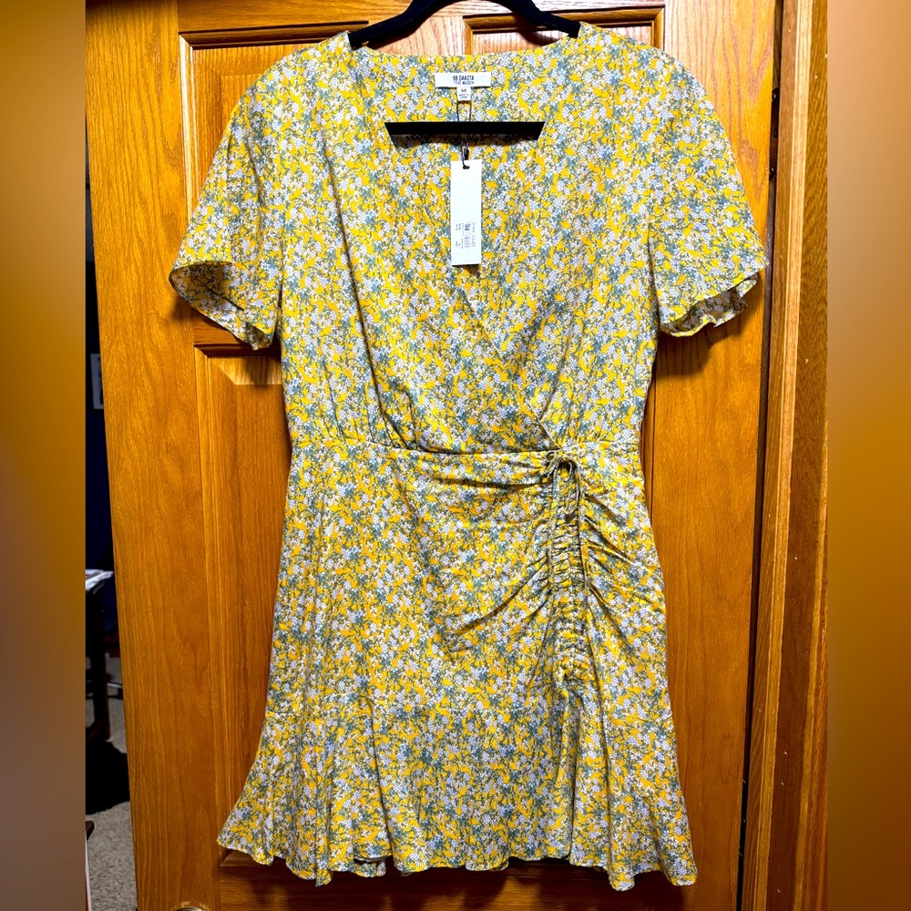 Yellow floral dress. Never worn. New with tag. Size medium.